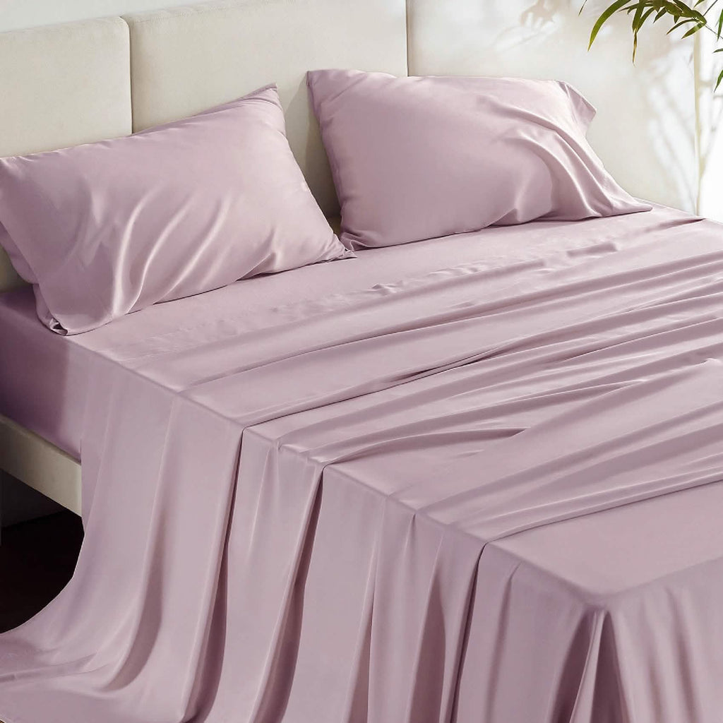 Dusty rose GentleSoft bamboo sheet set and pillowcases on bed, showing silky texture and smooth finish.