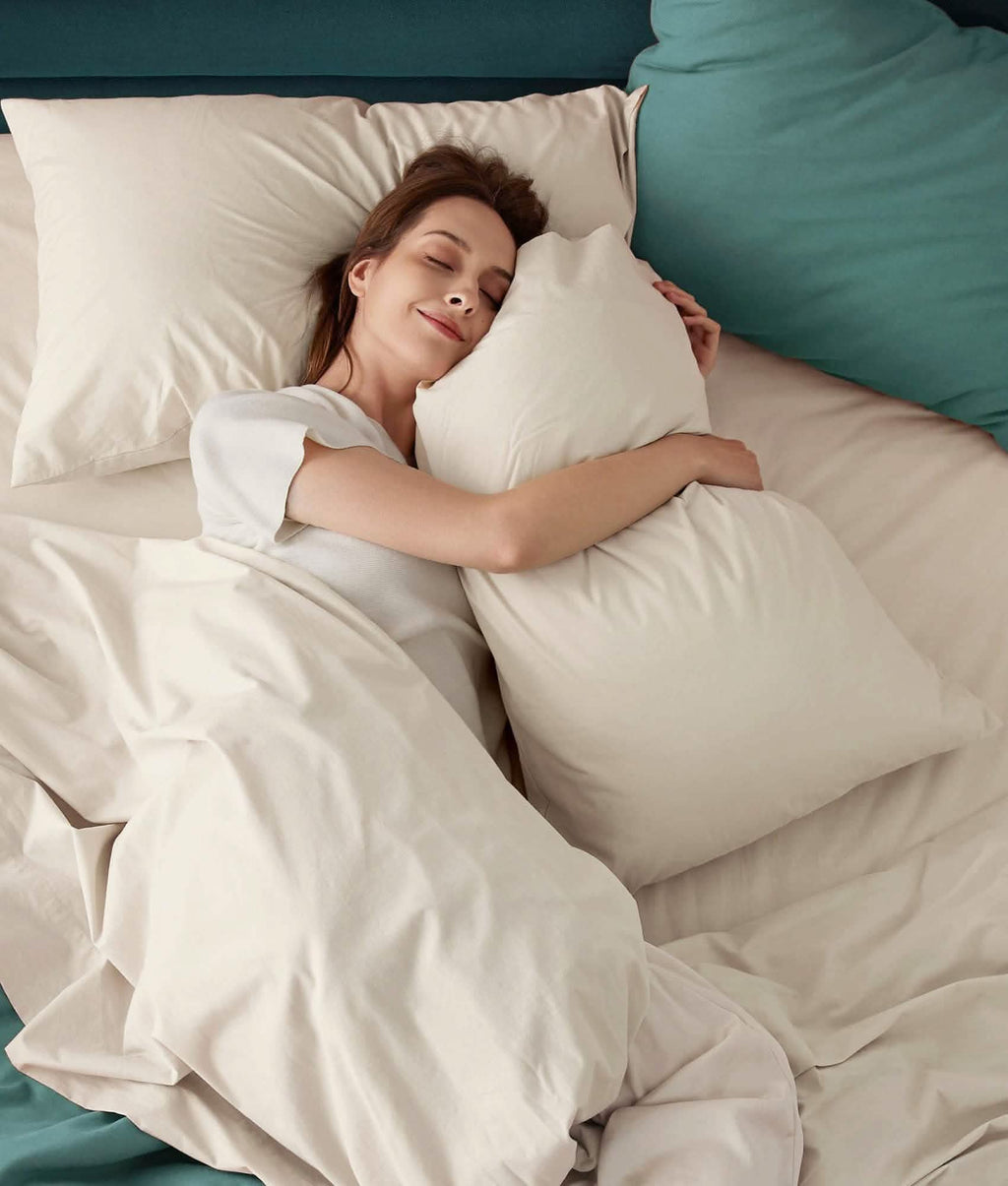 Woman sleeping on soft white 100% cotton percale weave sheet set.