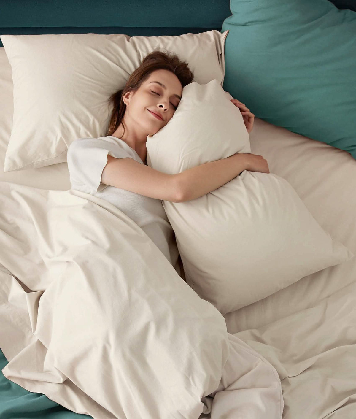 Woman sleeping on soft white 100% cotton percale weave sheet set.