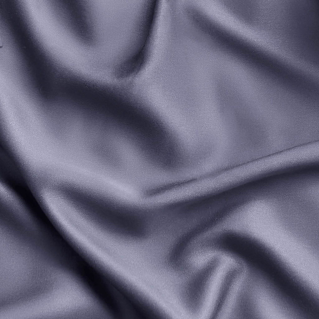 Close-up of muted lavender-gray rayon fabric from bamboo, showcasing silky texture and drape, GentleSoft sheet set material.