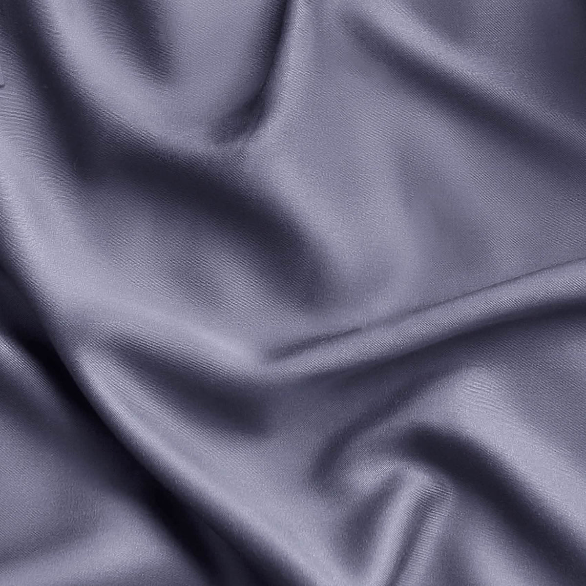 Close-up of muted lavender-gray rayon fabric from bamboo, showcasing silky texture and drape, GentleSoft sheet set material.