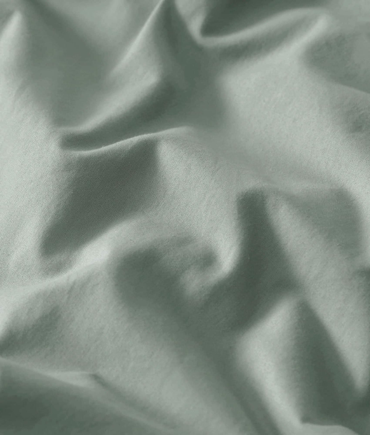 Soft, rumpled 100% cotton percale weave sheet set in muted green-grey.