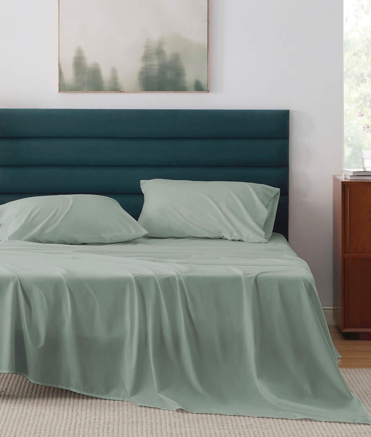 Soft sage green cotton percale sheet set on a bed